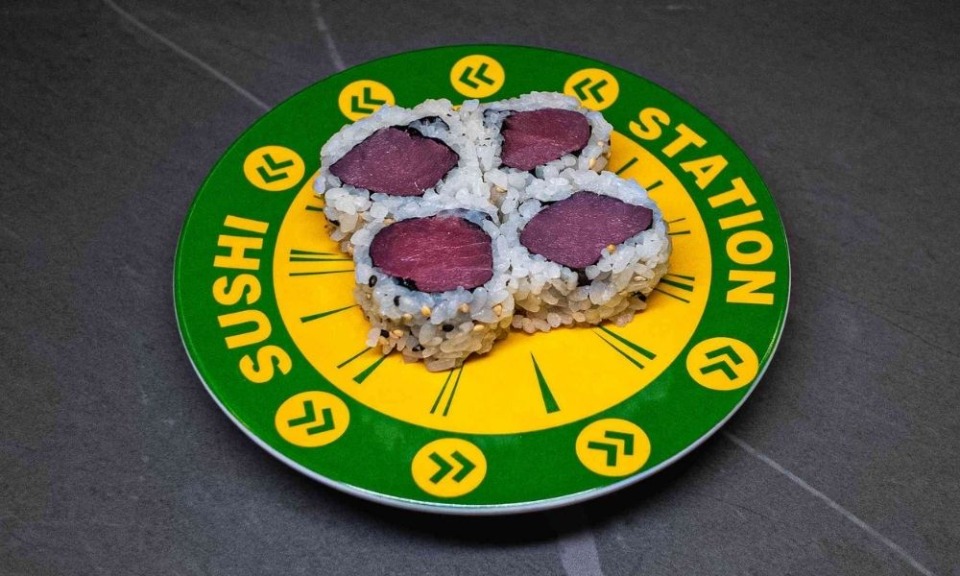 Sushi Station plate with four tuna nigiri pieces, green and yellow design, served at CROWDFAVORITES restaurant