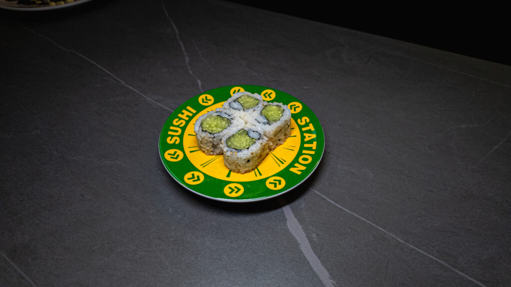 Four cucumber sushi rolls on a green and yellow "Sushi Station" plate, served at CROWDFAVORITES restaurant.