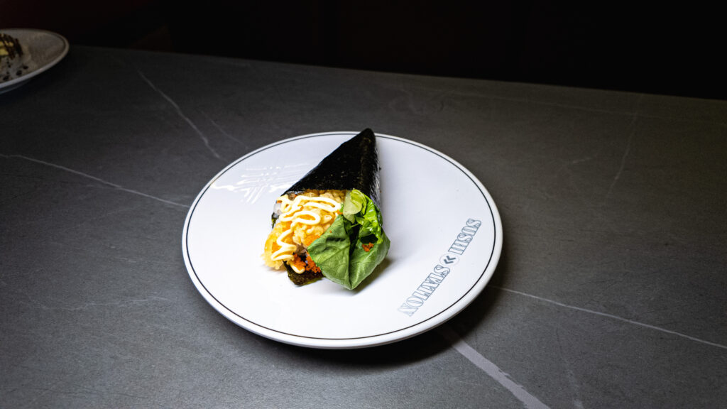 Crispy tempura sushi cone with lettuce and mayo on Sushi Station plate, served at CROWDFAVORITES restaurant.