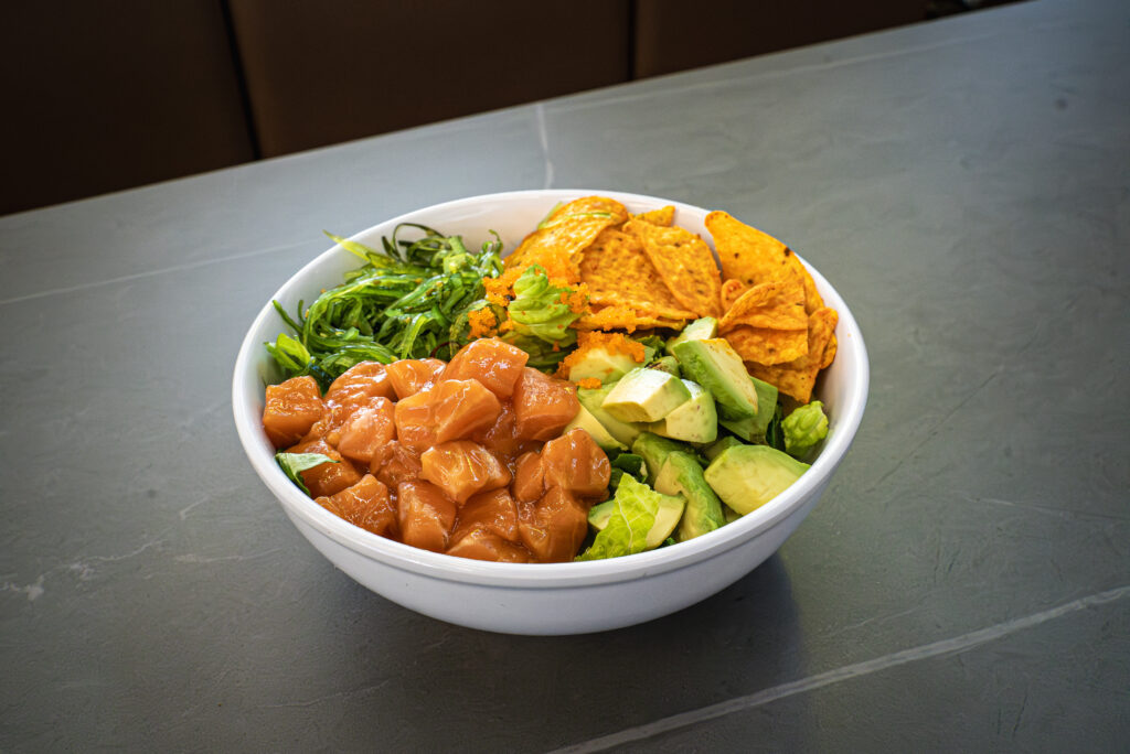 Spicy tuna poke bowl with avocado, seaweed salad, and tortilla chips at CROWDFAVORITES restaurant