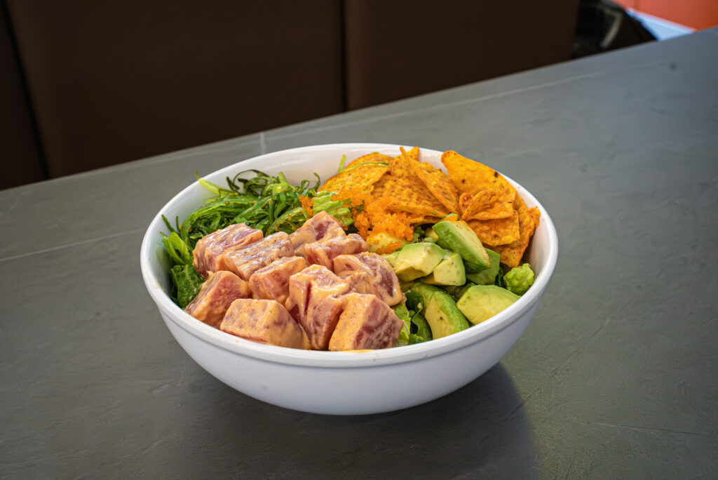 Fresh poke bowl with marinated tuna, avocado, seaweed, tortilla chips, and tobiko at CROWDFAVORITES restaurant
