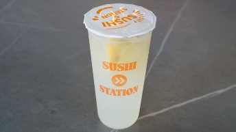 Sushi Station branded cup with lemonade, orange logo, and lid — perfect for on-the-go dining at CROWDFAVORITES restaurant