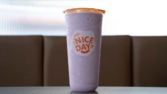 Purple smoothie in branded cup with “Nice Day” logo, served at CROWDFAVORITES restaurant, perfect for on-the-go refreshment.