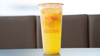 Sushi Station branded cup with orange drink, served at CROWDFAVORITES restaurant for refreshing dining experience