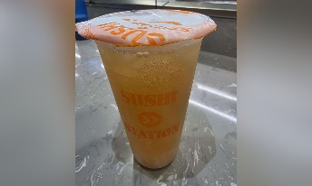 Sushi Station branded cup with orange drink and lid, served at CROWDFAVORITES restaurant location